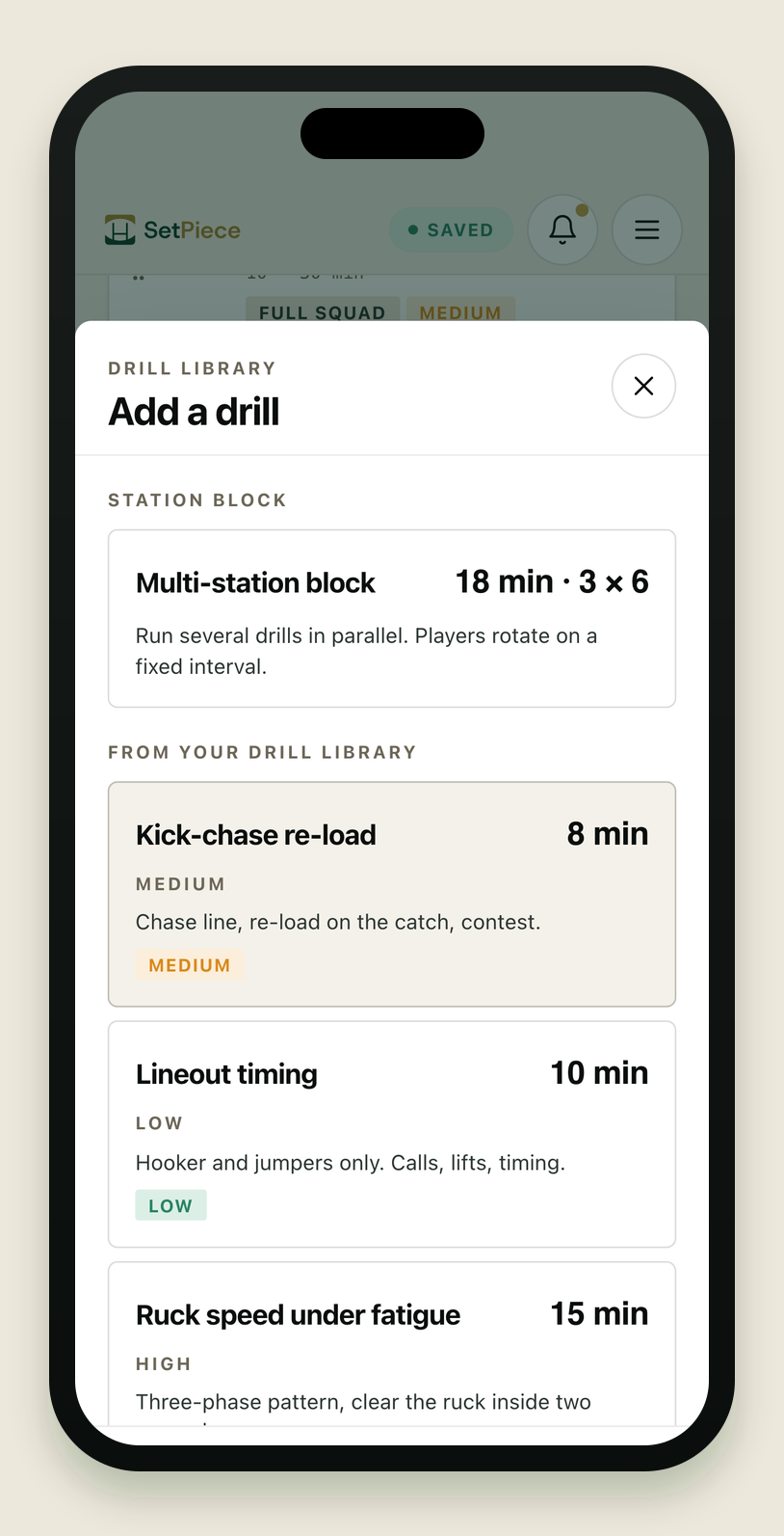The 'Drill library · Add a drill' picker, opened as a sheet over the session planner on an iPhone. The sheet lists ready-made drills to drop into the open session. At the top, a 'Station block' card offers a Multi-station block (18 min · 3 × 6) for running drills in parallel with player rotations. Below, a 'From your playbook' section shows the 'Slider' play with its pitch thumbnail, so an existing play can be dropped straight into the session. A pinned '+ Add blank drill' button sits at the bottom of the sheet.